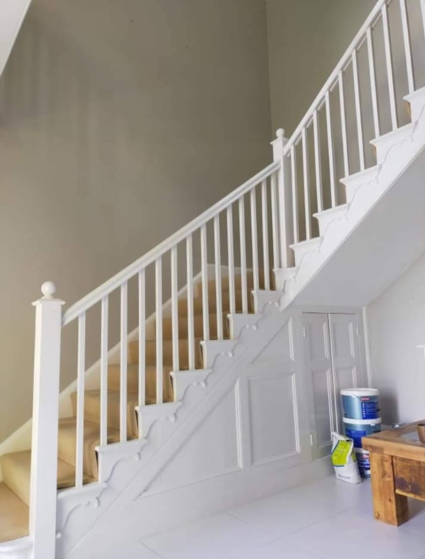 A picture of a staircase newly painted brilliant white by Painting and Decorating Nottingham