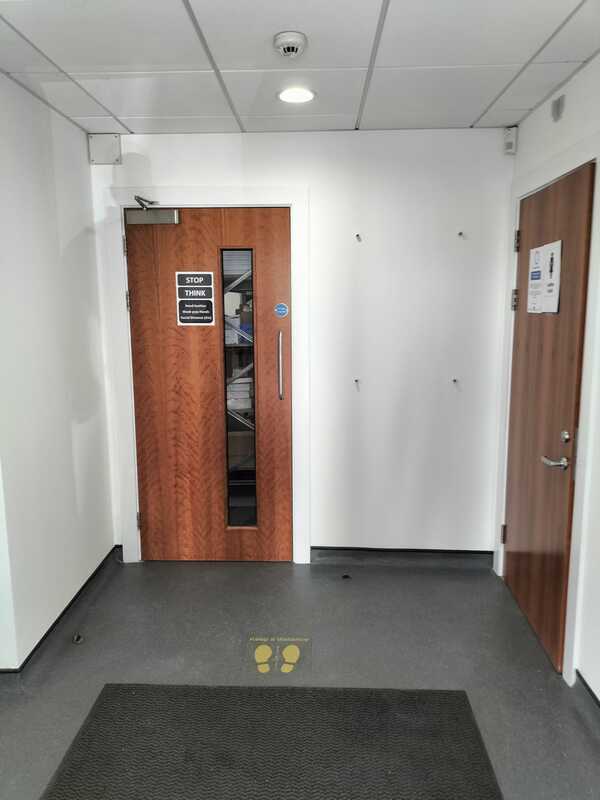 Picture of an office corridor and fire doors painted by painters and decorators Nottingham 