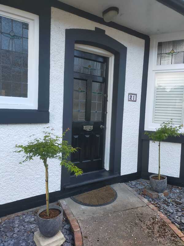 A picture of newly painted front door and render. The colour is black and white, completed by Painters and Decorators Nottingham