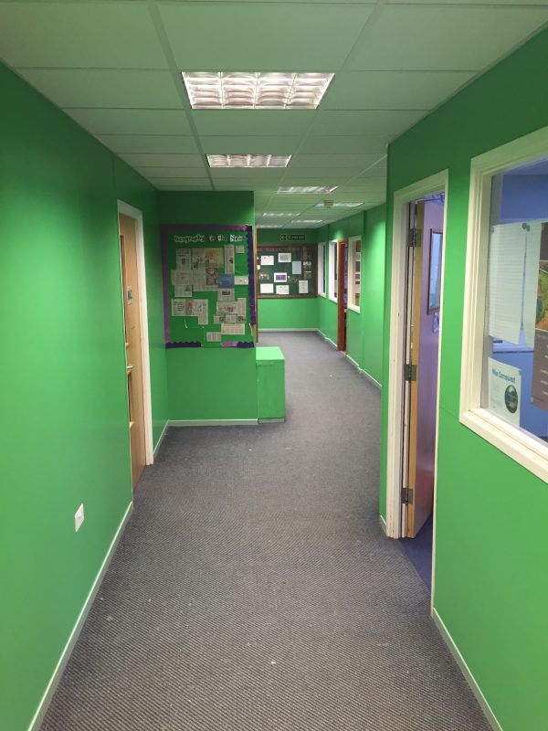 A picture of an office corridor painted light green by Painters and Decorators Nottingham
