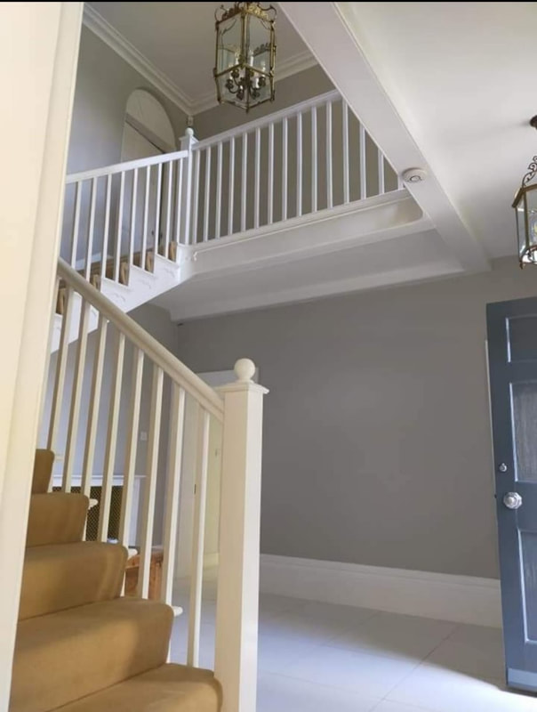 A picture of a newly decorated landing and hallway. Walls and bannister have been newly painted by Painters and Decorators Nottingham