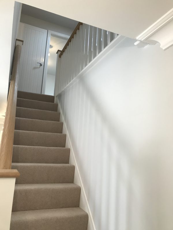 A picture of a staircase painted white matte by Painters and Decorators Nottingham